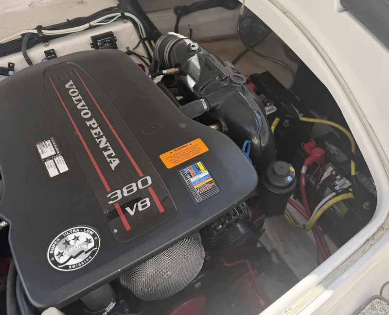 Slide: The Image of The engine compartment of a 2013 Chaparral 264 Sunesta features a Volvo Penta 380 V8 engine. - 25