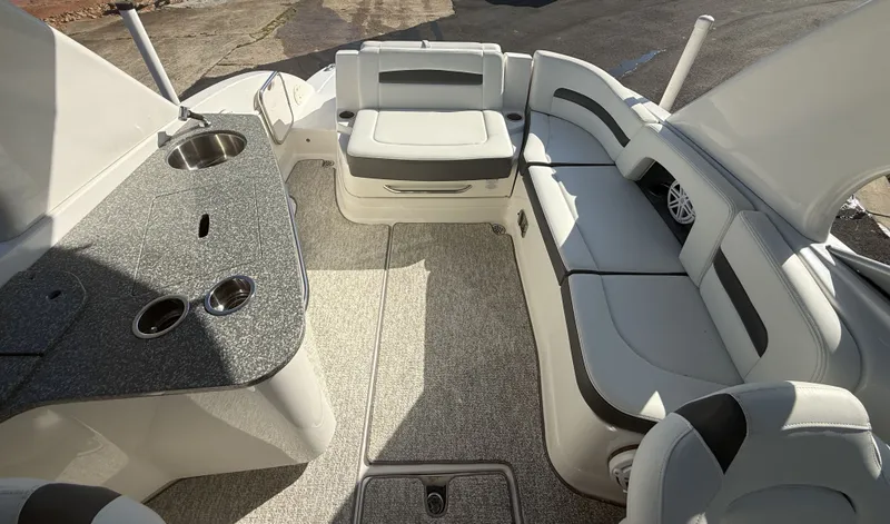 Slide: The Image of Interior of a 2013 Chaparral 264 Sunesta with gray carpet and white upholstery. - 14