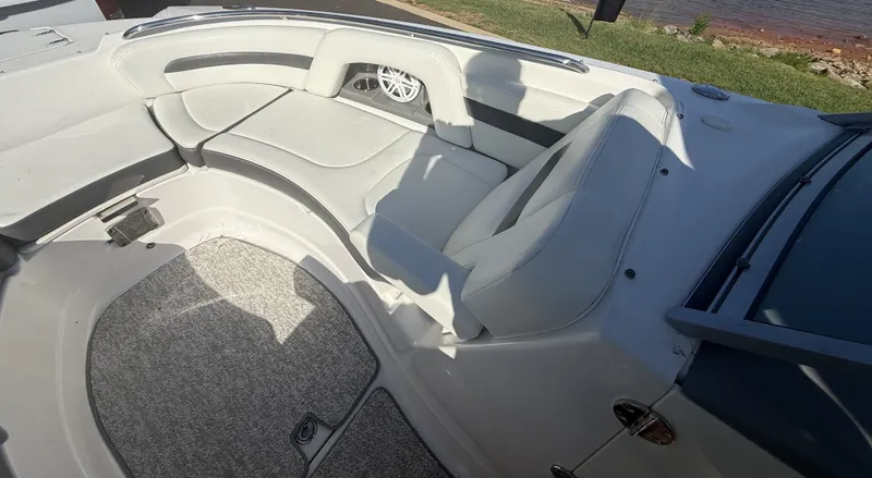 Slide: The Image of The image shows the cockpit of a 2013 Chaparral 264 Sunesta boat with white upholstery. - 18