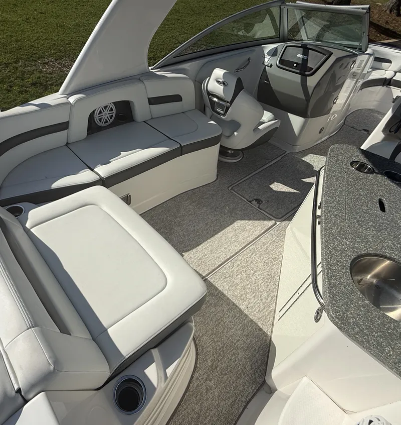 Slide: The Image of The image shows the cockpit of a 2013 Chaparral 264 Sunesta with sleek seating and a helm station. - 15