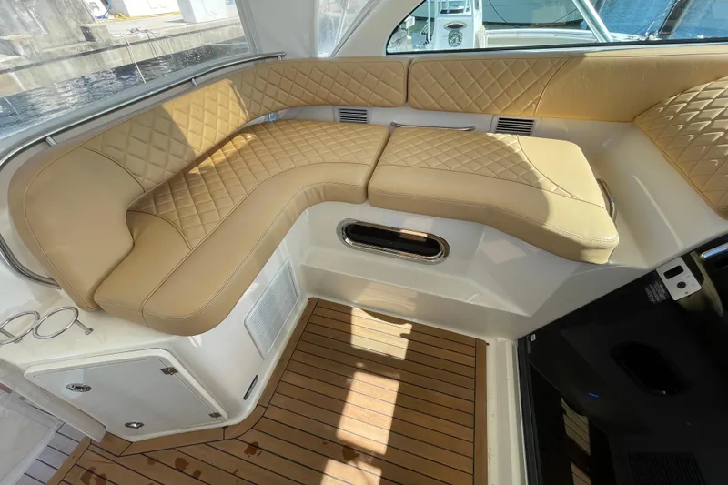 Slide: The Image of Luxurious seating on 2010 Pursuit OS 375 Offshore boat with tan quilted upholstery. - 25