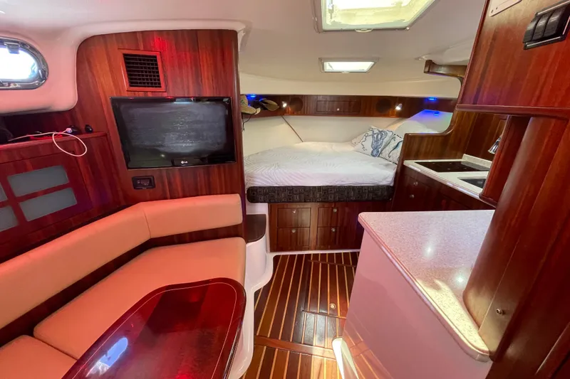 Slide: The Image of Luxurious interior of 2010 Pursuit OS 375 Offshore boat with cozy seating and bed. - 27