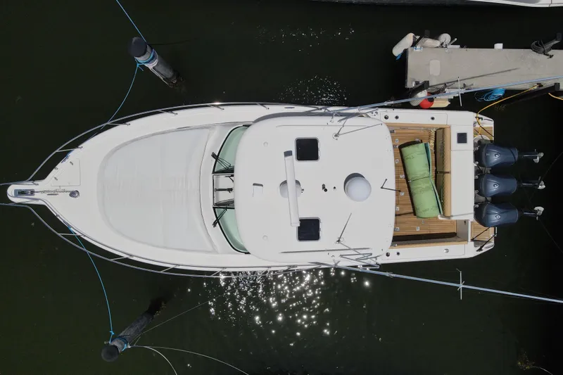 Slide: The Image of Overhead view of a 2010 Pursuit OS 375 Offshore boat docked at a marina. - 44