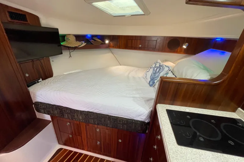 Slide: The Image of Luxurious cabin interior of 2010 Pursuit OS 375 Offshore boat with cozy bed and kitchenette. - 33