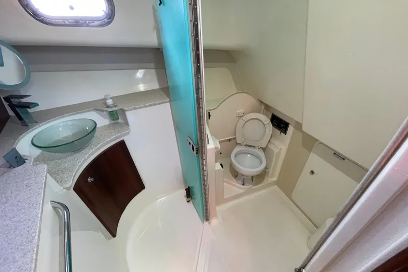Slide: The Image of 2010 Pursuit OS 375 Offshore boat bathroom with modern fixtures and glass sink. - 34