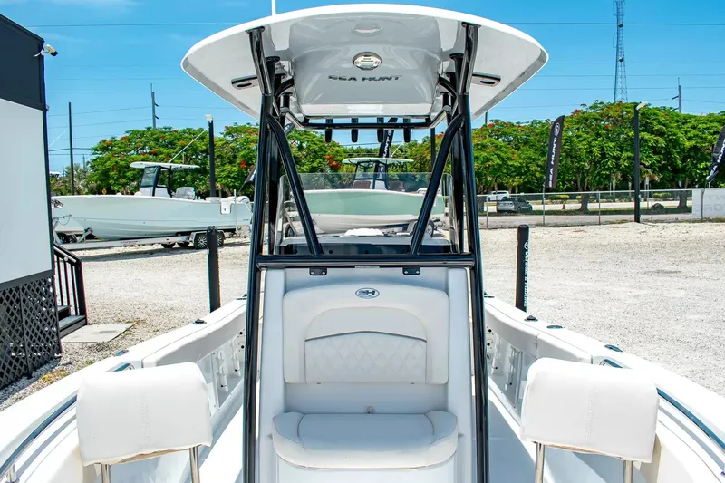Slide: The Image of The image shows the cockpit of a 2027 Sea Hunt Ultra 219 boat with white seating. - 20
