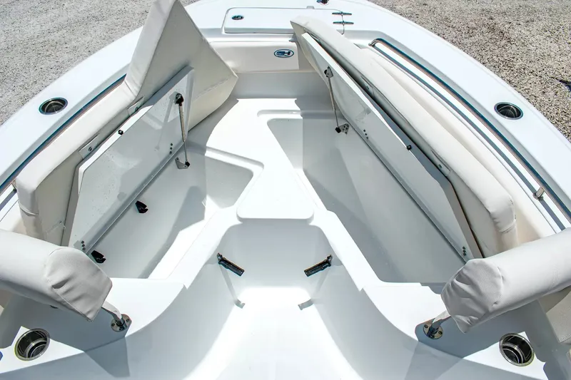 Slide: The Image of The image shows the bow area of a Sea Hunt Ultra 219 boat with white cushioned seats. - 23