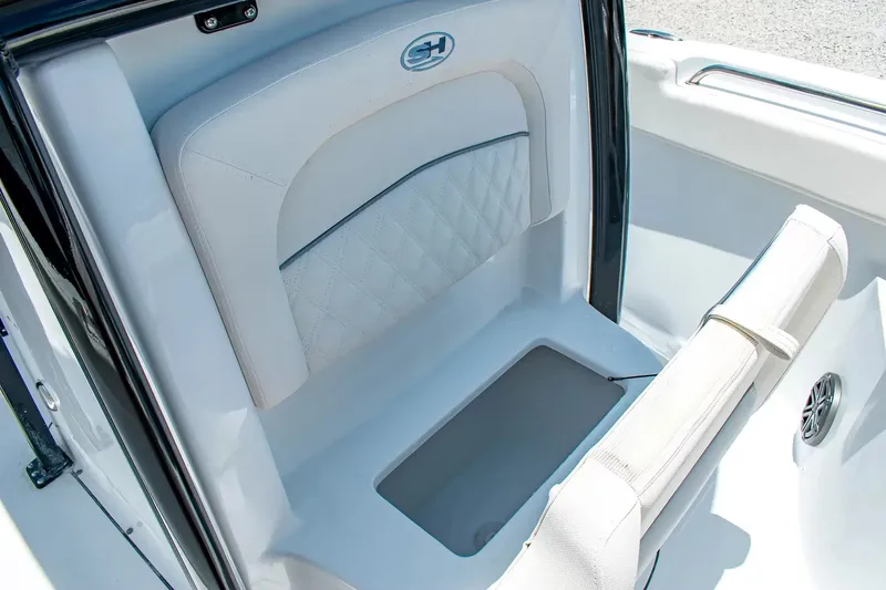 Slide: The Image of The image shows a seating area on a Sea Hunt Ultra 219 boat with white upholstery. - 21
