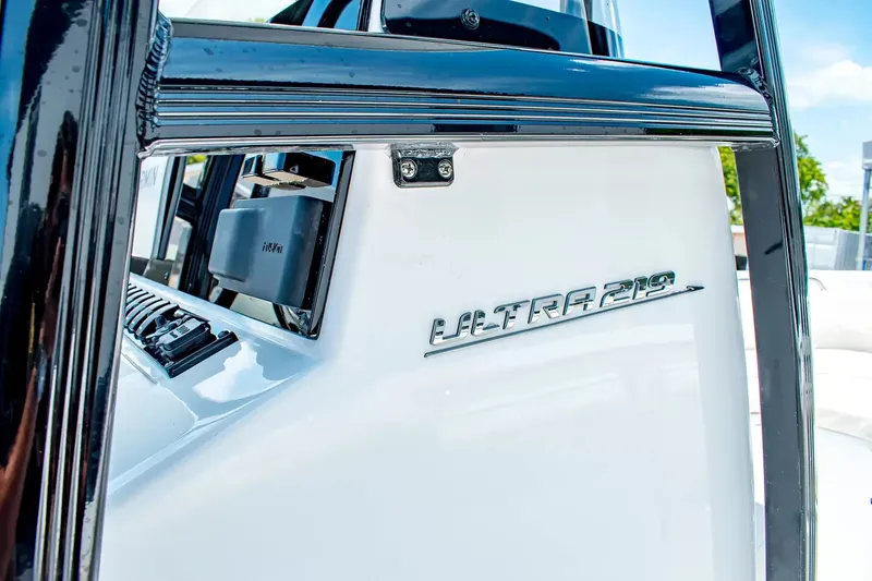 Slide: The Image of Close-up of the Sea Hunt Ultra 219 boat, year 2027, featuring a sleek white hull. - 16
