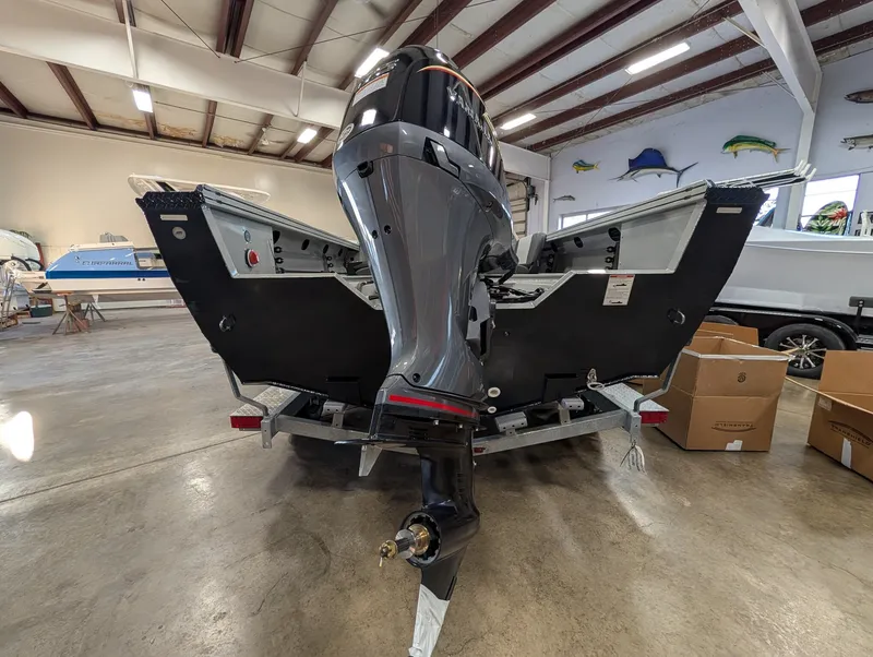 Slide: The Image of A 2026 Smoker Craft Phantom 20 X2 in a warehouse. The outboard motor is visible. - 18
