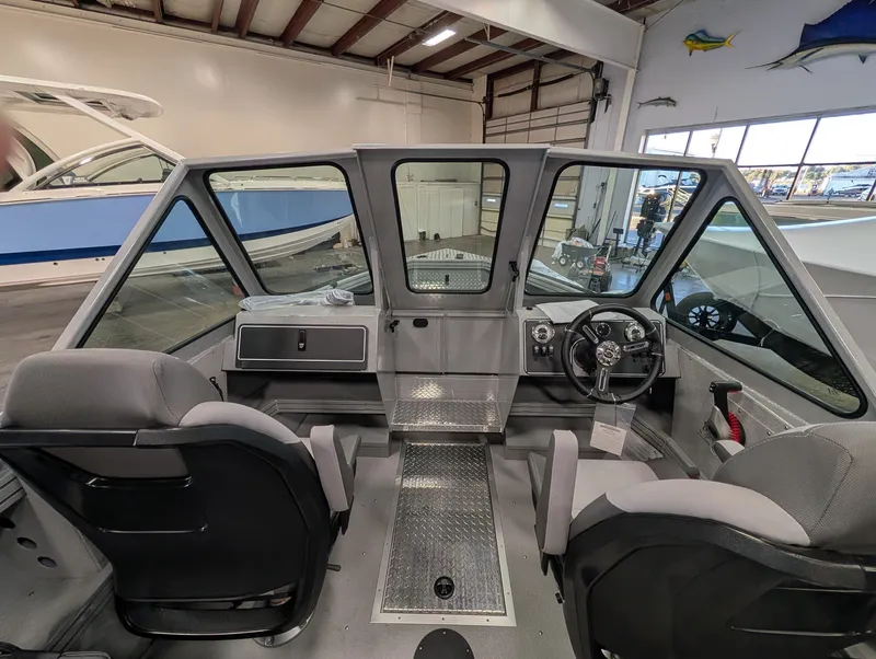 Slide: The Image of The image shows the cockpit of a 2026 Smoker Craft Phantom 20 X2 with gray seats and a modern helm. - 33