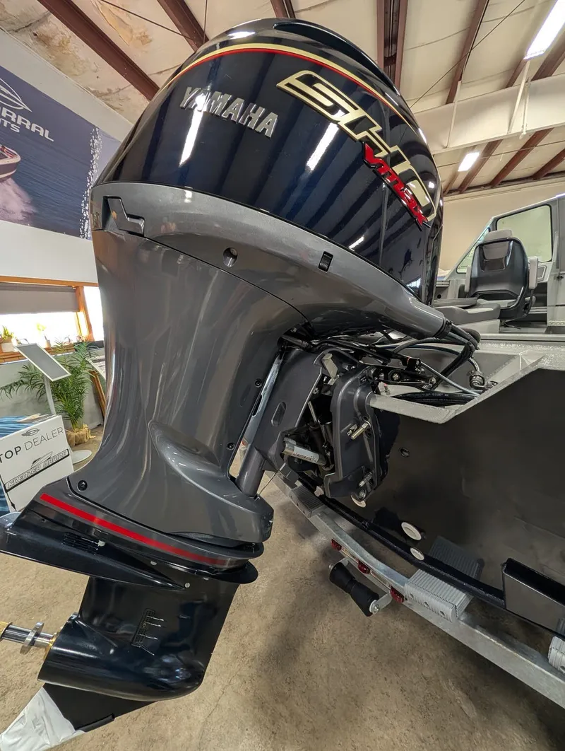 Slide: The Image of A Yamaha outboard motor is mounted on a boat, which is on a trailer indoors. - 24