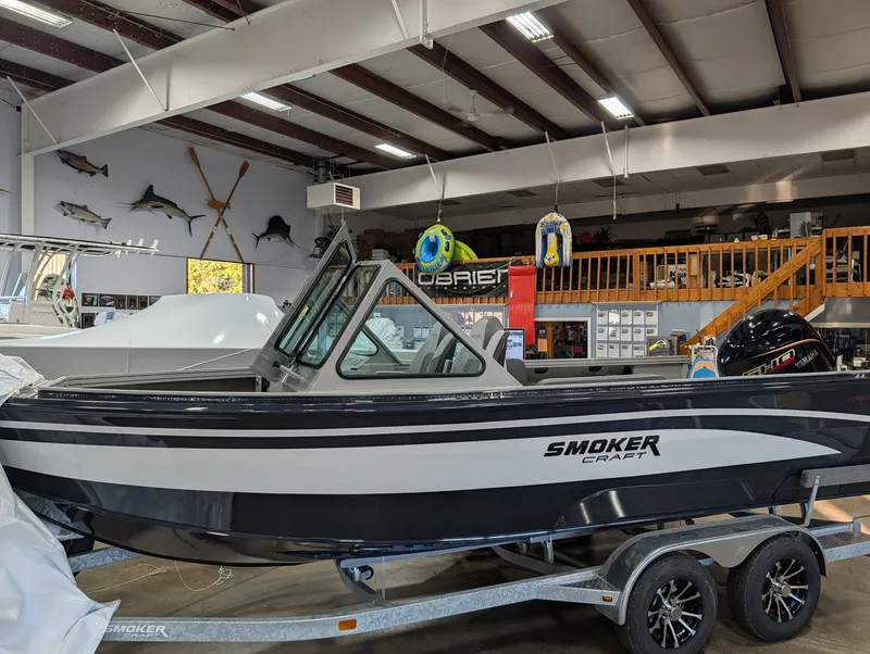 The Image of A 2026 Smoker Craft Phantom 20 X2 sits on a trailer in a showroom. - 1