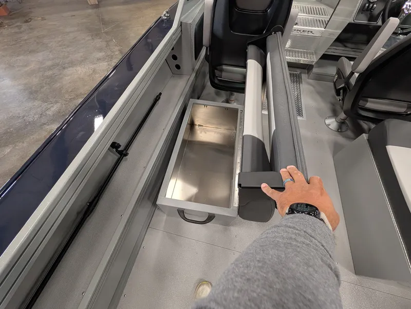Slide: The Image of A person opens a storage compartment on a Smoker Craft Phantom 20 X2 boat. - 28