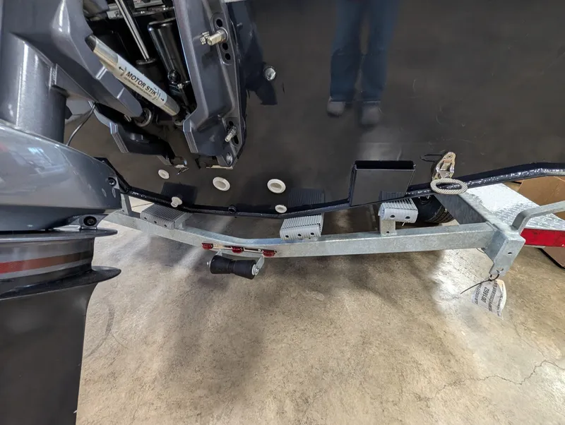Slide: The Image of Close-up of a boat's stern on a trailer, showing the motor and trailer hitch. - 25