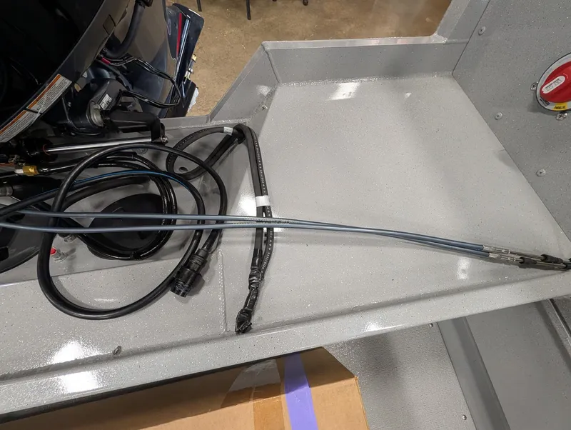 Slide: The Image of Close-up of cables and hoses inside a boat, on a gray surface. - 16