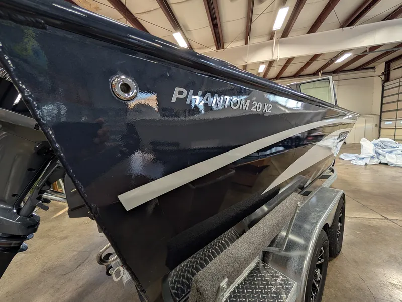 Slide: The Image of A 2026 Smoker Craft Phantom 20 X2 boat is on a trailer inside a warehouse. - 26