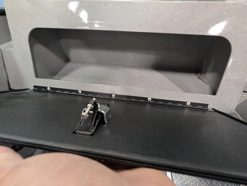 Slide: The Image of An open storage compartment with a flap and a latch mechanism. - 36