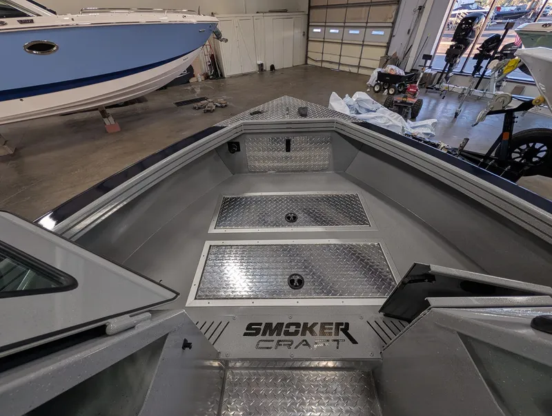 Slide: The Image of The image shows the interior of a Smoker Craft Phantom 20 X2 boat with aluminum decking. - 29