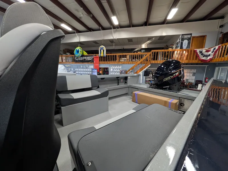 Slide: The Image of Interior view of a Smoker Craft Phantom 20 X2 boat with gray seating and an outboard motor. - 22