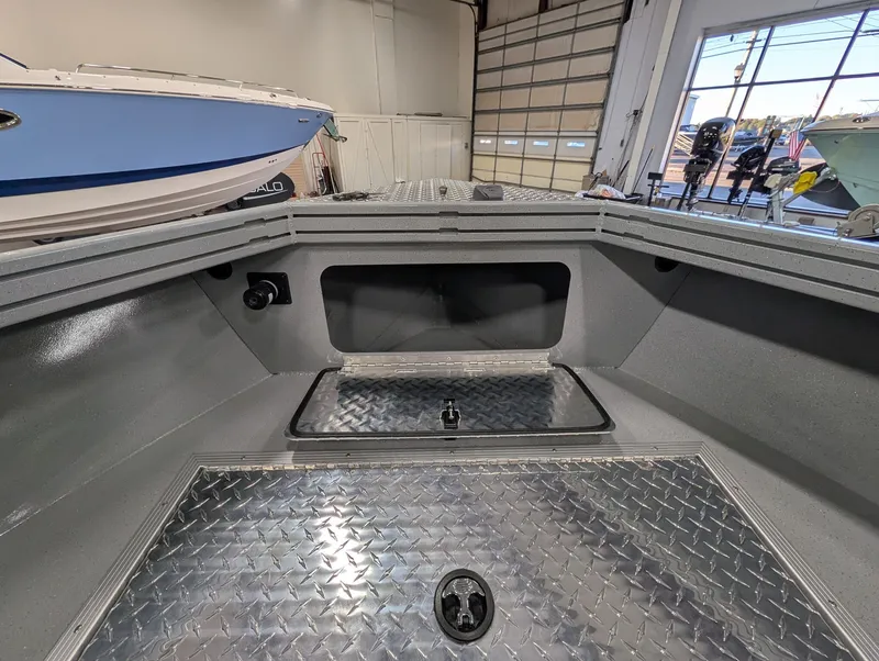 Slide: The Image of The image shows the interior of a 2026 Smoker Craft Phantom 20 X2 boat with a metal floor. - 30