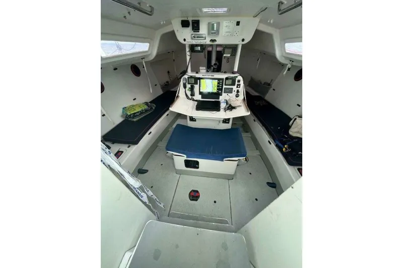 Slide: The Image of Interior of 2007 Class 40 Akilaria MK1 sailboat, featuring navigation equipment and seating. - 13