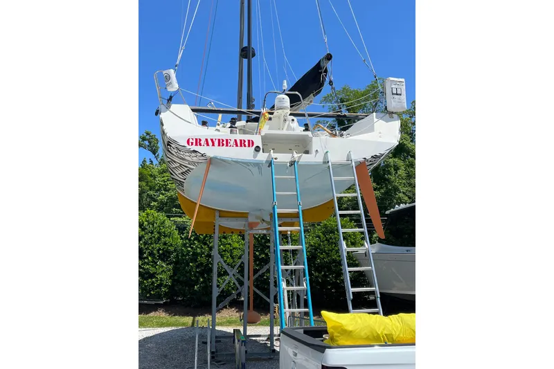 Slide: The Image of Sailboat "Graybeard" on stands, Class 40 Akilaria MK1, 2007, with ladders and greenery. - 26
