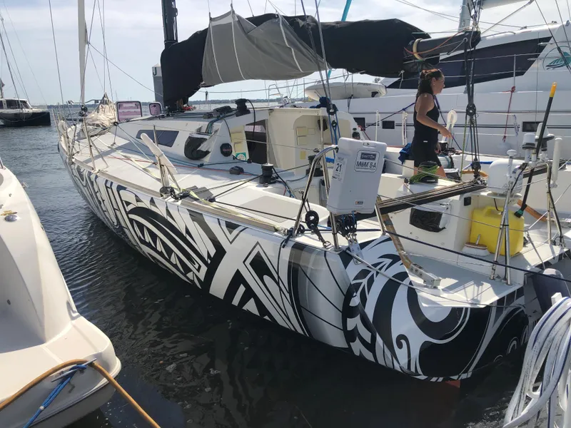 Slide: The Image of 2007 Akilaria MK1 Class 40 sailboat with striking design in harbor. - 19
