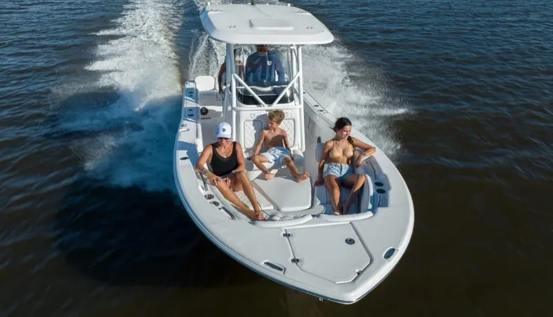 The Image of Three people relax on a Sea Fox 248 Commander boat speeding across the water. - 1