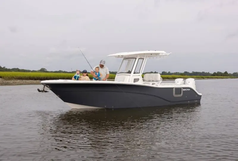 The Image of The 2027 Sea Fox 268 Commander is on calm water. Three people are fishing on board. - 1