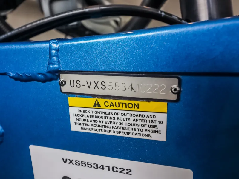Slide: The Image of Close-up of a blue boat hull with serial number and caution label. - 22