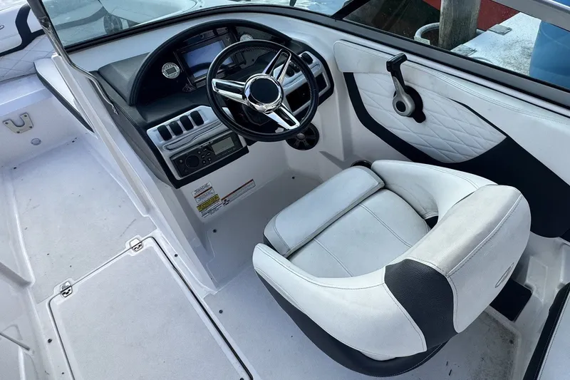 Slide: The Image of Cockpit of 2018 Regal 23 OBX boat with steering wheel and captain's chair. - 4