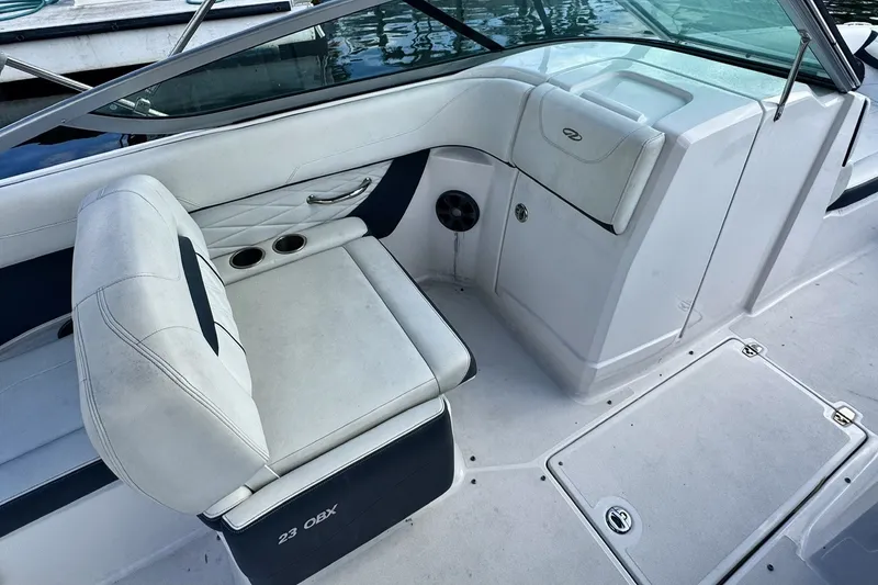 Slide: The Image of 2018 Regal 23 OBX boat interior with white seating and cup holders. - 3