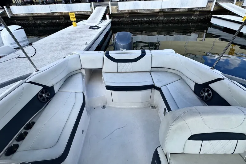 Slide: The Image of 2018 Regal 23 OBX boat interior with white seating at a dock. - 7