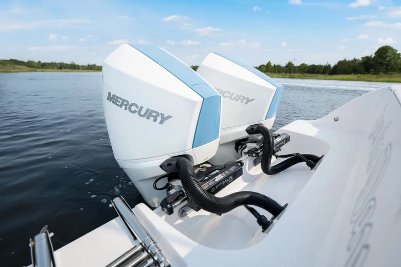 Slide: The Image of 2024 Sportsman Open 262 Center Console with dual Mercury outboard engines on water. - 22