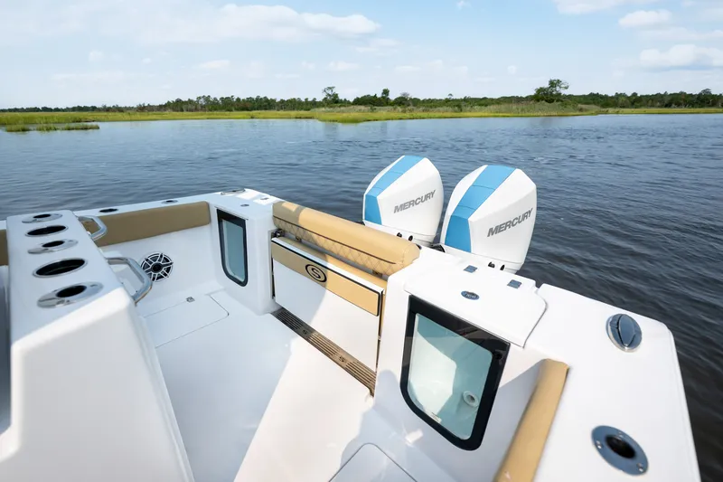 Slide: The Image of 2024 Sportsman Open 262 Center Console boat with dual Mercury engines on a serene lake. - 18