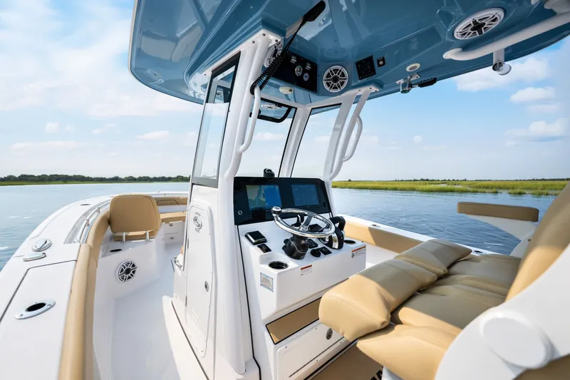Slide: The Image of 2024 Sportsman Open 262 Center Console boat interior with modern helm and seating. - 13