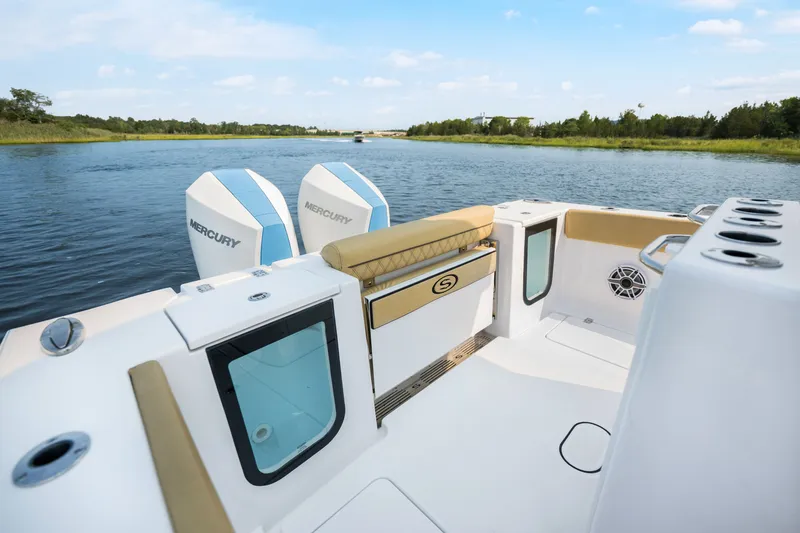 Slide: The Image of 2024 Sportsman Open 262 Center Console boat with dual Mercury engines on a serene waterway. - 19