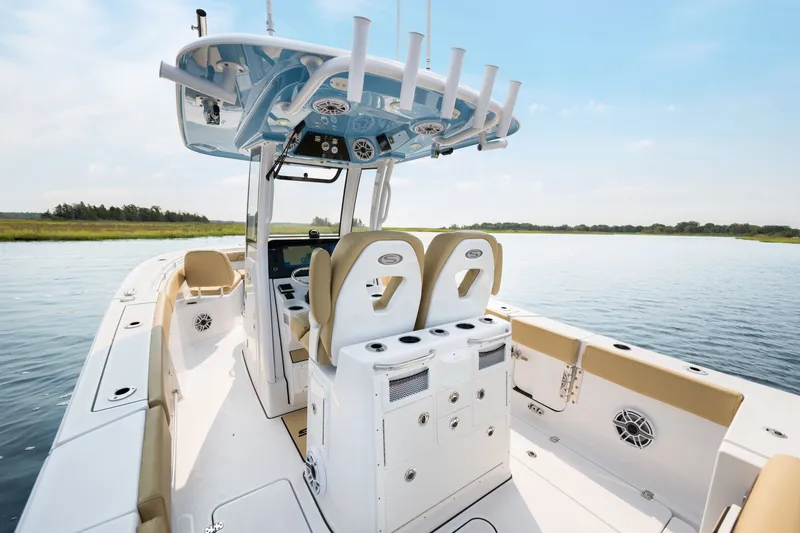 Slide: The Image of 2024 Sportsman Open 262 Center Console boat on calm water, showcasing seating and console features. - 20