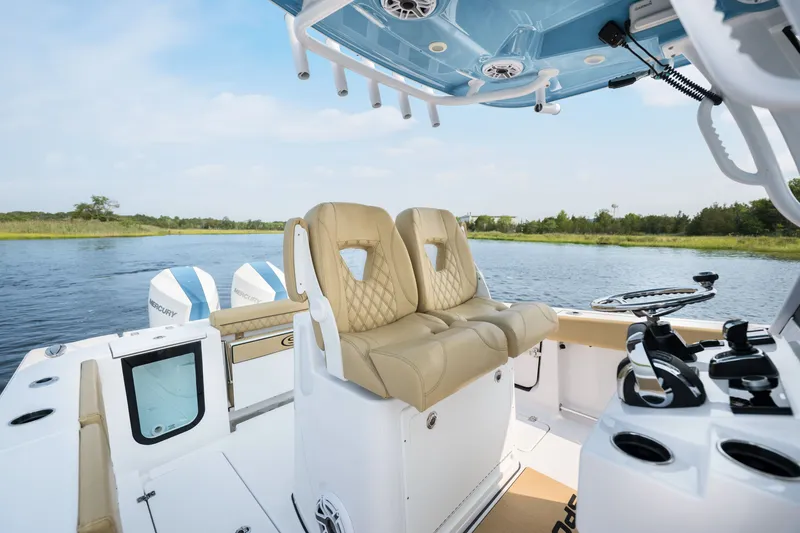 Slide: The Image of 2024 Sportsman Open 262 Center Console boat interior with dual seats and water view. - 16