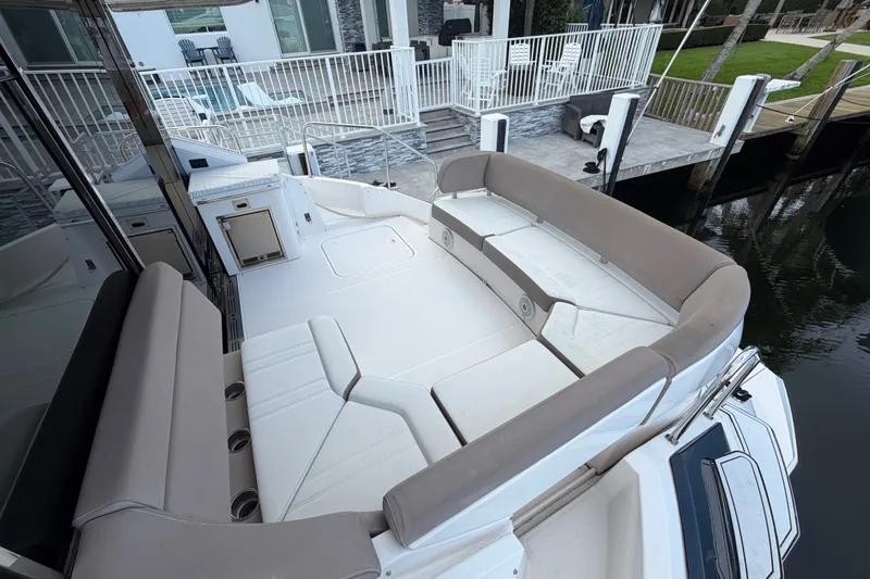 Slide: The Image of 2018 Regal 53 Sport Coupe yacht with spacious seating area and modern design. - 35