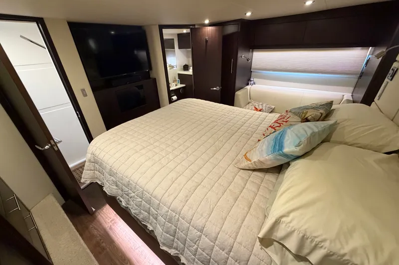 Slide: The Image of Luxurious bedroom interior of 2018 Regal 53 Sport Coupe yacht with cozy bedding. - 108