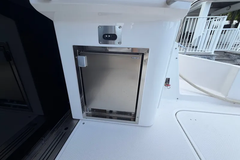 Slide: The Image of 2018 Regal 53 Sport Coupe yacht interior with stainless steel mini fridge. - 31