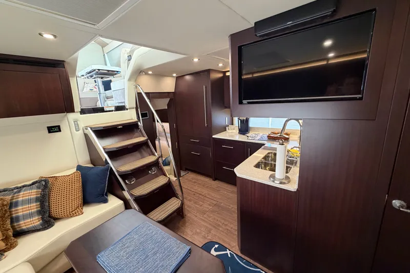 Slide: The Image of Luxurious interior of 2018 Regal 53 Sport Coupe yacht with modern kitchen and seating area. - 113