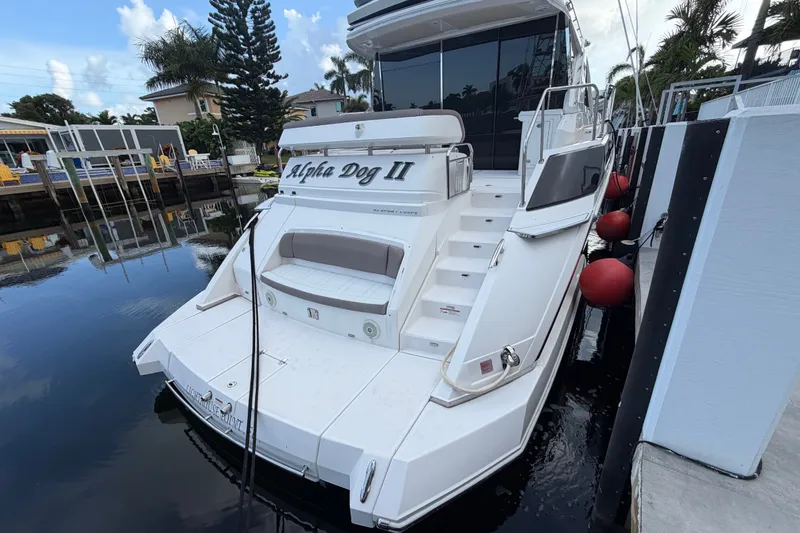 Slide: The Image of 2018 Regal 53 Sport Coupe yacht docked, featuring spacious deck and sleek design. - 11