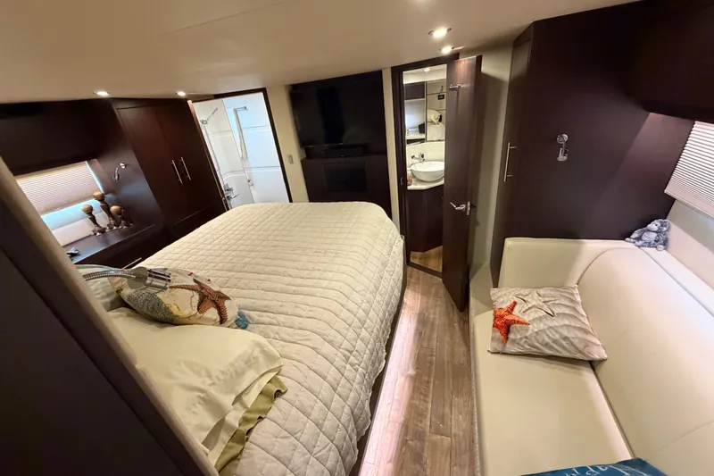 Slide: The Image of Luxurious bedroom interior of 2018 Regal 53 Sport Coupe yacht with cozy bedding and elegant decor. - 99