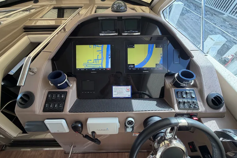 Slide: The Image of Control panel of a 2018 Regal 53 Sport Coupe with navigation screens and steering wheel. - 72