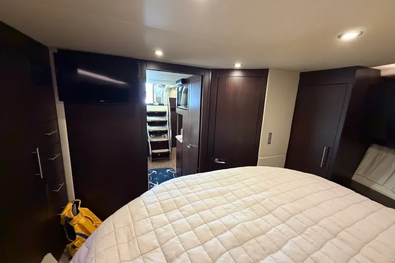 Slide: The Image of Interior of 2018 Regal 53 Sport Coupe yacht bedroom with TV and modern furnishings. - 120