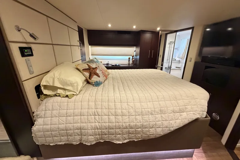 Slide: The Image of Luxurious bedroom interior of 2018 Regal 53 Sport Coupe yacht with cozy bedding and modern decor. - 100