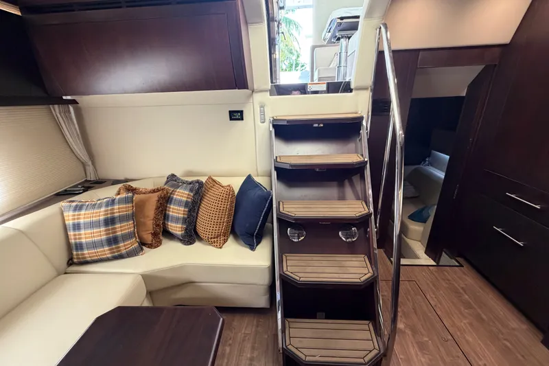 Slide: The Image of Interior of 2018 Regal 53 Sport Coupe with plush seating and wooden stairs. - 94